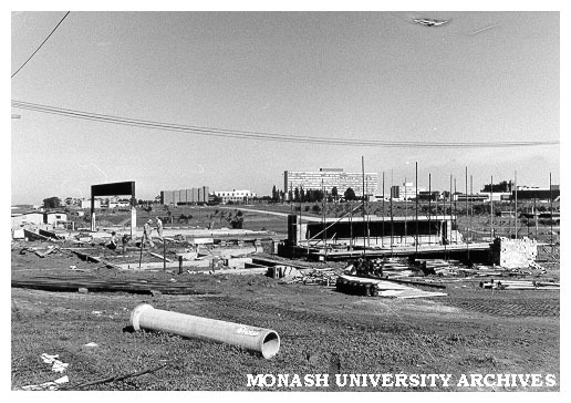 Early construction of Roberts [?] Hall with university buildings in background
