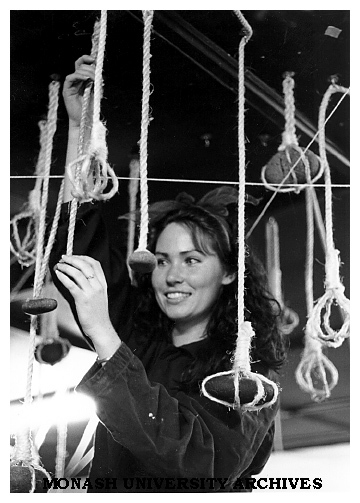Artist-in-residence Fiona McCullough with finished work comprising raw rope and rock suspended from the ceiling of the Union building