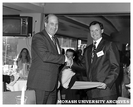 Antony Edwards (right) receiving the Mayne Nickless Award in marketing from Peter Cowley