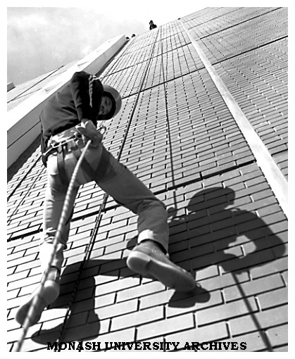 Third year science student Peter Brenton abseiling down library wall during Open Day