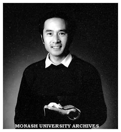 Dr Yuan Gao, Department of Physiology, holds a mouse eating grains embedded with a fertility control compound