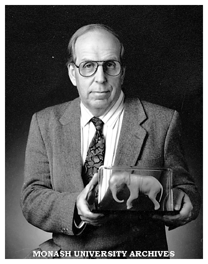 Professor Roger Short holds a model of an African elephant