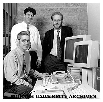 Monash publishing staff senior publications officer Mr Tim Mansour (seated), publications officer Mr Anthony Lynch (standing left) and manager Mr John Wilkins