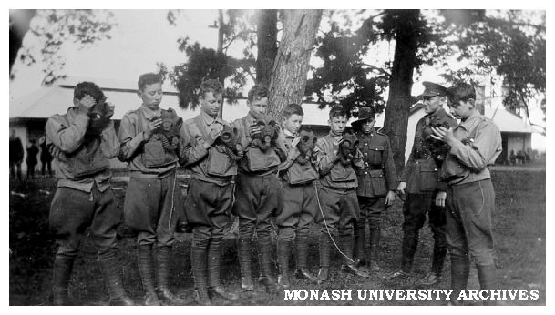 Caulfield Technical School cadet camp. Gas respirator drill with Lieutenant D. Hall