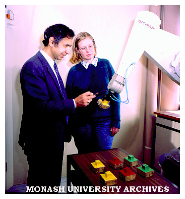 Gippsland senior lecturer Ibrahim Yousef demonstrates robotic arm to Engineering student