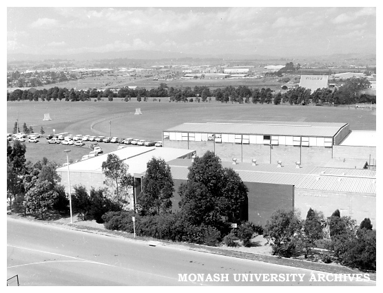 Monash Sports Centre and playing fields with Village drive-in in background