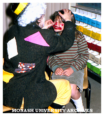 Primary school student being painted in art education class