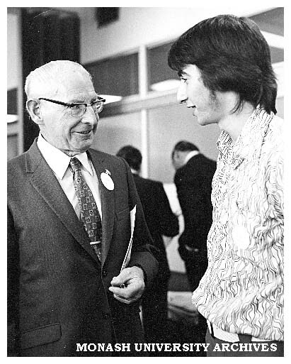 Harry Green (left), inaugural blacksmithing teacher talks to Paul Ramler, President Student Union Council at the Caulfield Institute of Technology 50th anniversary celebrations