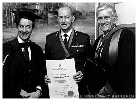 Chief Commissioner Miller (centre) receives his award of a Fellowship of Chisholm Institute. He is pictured with Dr Lionel Ward, President of Council (left) and Chisholm Director Dr Geoff Vaughan