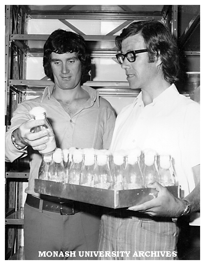 PhD student Peter Hanna (left) and Dr Ken Dyer with bottles of 'superflies' mutated to withstand massive doses of organoposphate insecticides