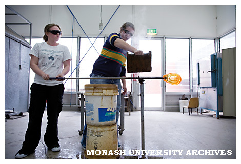 Bachelor of Fine Arts Honours students Tegan Hamilton and Suzannah Terauds blow glass bubbles to warm up their tools during assessment at Caulfield campus