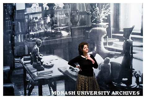 Dr Janine Burke, Research Fellow in the School of English, Communications and Performance Studies, in front of a photograph of Freud's desk in Vienna.