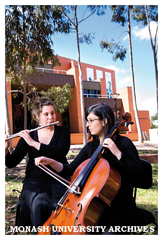 Chamber music students Amy Tcheupdjian (cello) and Surekha Curkpatrick (flute) in the forecourt of the Performing Arts Centre with Robert Blackwood Hall in the background