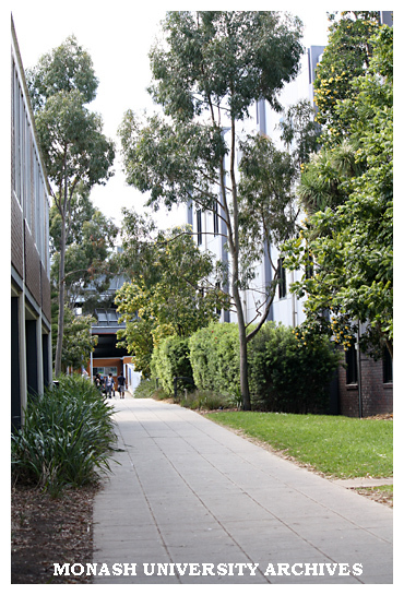 Footpath to multi-level car park (north), Clayton campus, with Mathematics building on left.