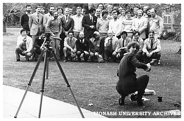 Electrical Engineering staff and students, with photographer Julie Fraser in foreground, changing lenses.