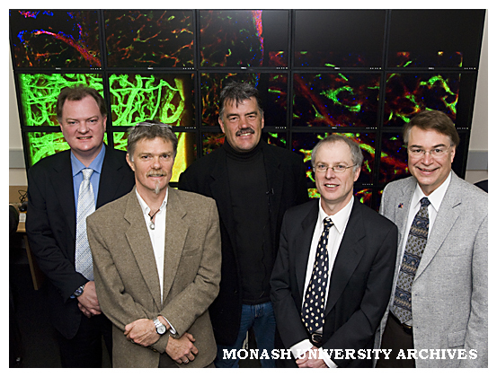 Professor Paul Bonnington, Dr Ian Harper, Associate Professor Martin Lackmann, Professor David Abramson and Professor Larry Smarr in front of the OptiPortal wall at Monash Micro Imaging.