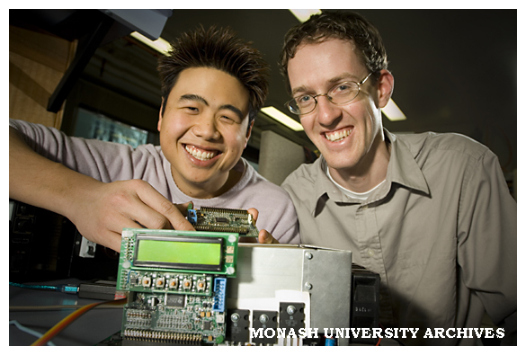 Engineering students Mr John Luo (left), and Mr Chris Beckett with two models of a prototype power inverter.