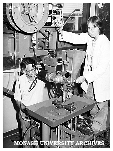 Gillian Heintze conducting an experiment on a large-scale welding rig, with Associate Professor Reg McPherson.