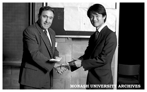 Lim Hock Gin (right) receiving the Digital Equipment prize for the best project in digital electronics or computer engineering from Mr John Baker.