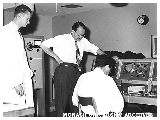 Installing nuclear magnetic resonance spectroscope. Peter Godfrey (left) and Major Tony Bridges.