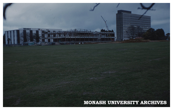 Administration building under construction, with Main Library and Menzies Building in background