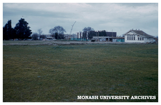 Administration Building, Library and Union under construction, Talbot school house in foreground