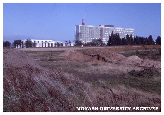 Menzies Building under construction; Main Library and Administration Building at left