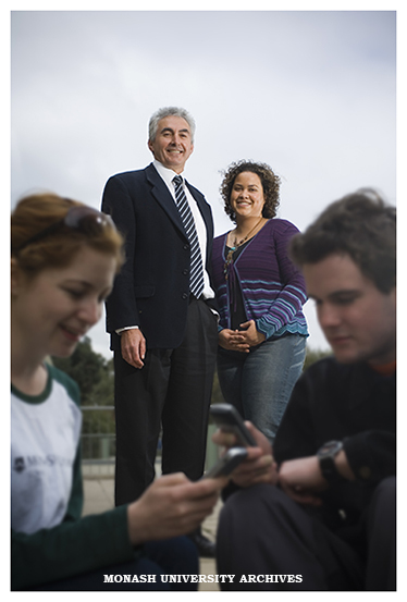 Student and Community Services Examinations Manager Vern Garth and Student Systems web coordinator Brigitte Auguste with students receiving their results via SMS.