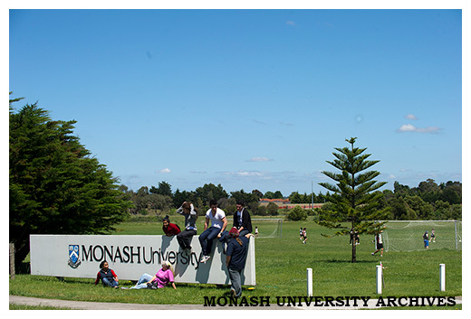 Students by Monash University sign, Berwick campus