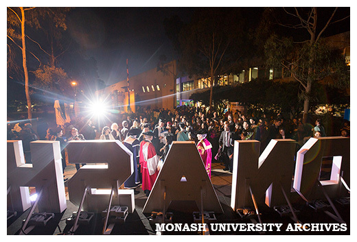 Law graduates celebrating with family and friends outside campus centre with (from right to left) Chancellor Alan Finkel, honorary graduate Michael Kirby, and Dean of Law Bryan Horrigan