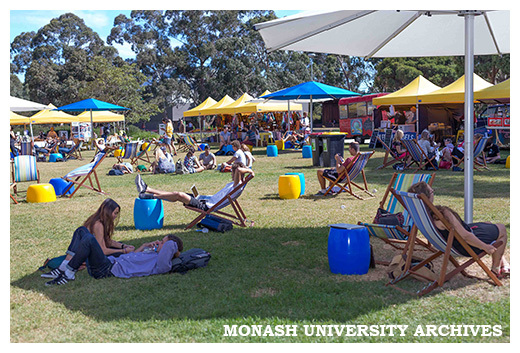 Market at Clayton campus - students relaxing on Lemon Scented Lawns with food trucks, market stalls