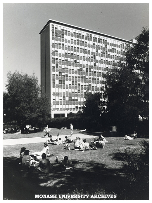 Menzies building and students sitting on lawn in forum