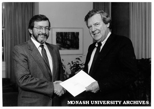Professor Mal Logan receives a cheque from Mr Peter Cook (Minister for Industrial Relations) to fund the National Key Centre in Industrial Relations