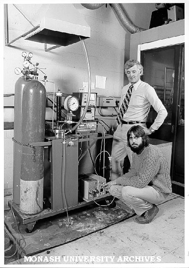 Dr Alan Holder (standing) and research assistant Russell Mills with reactor vessel