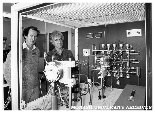 Associate Professor Ron Dickson (right) and Dr Ian Christiansz of Telecom Research Laboratories looking at metal organic chemical vapour deposition equipment