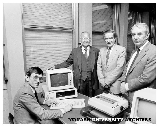 Mr Gordon McAuslan of IBM (second from left) with PC donated to Faculty of Economics and Politics. With him from left: Dr Rob Willis, Professor Ray Martin, and the Dean Professor Gus Sinclair