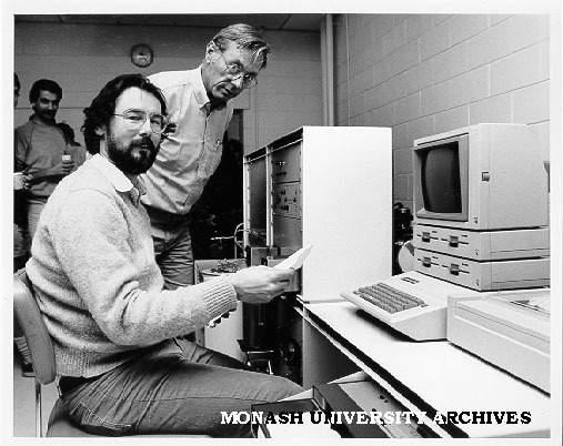 Dr Bob Gregory at isotope ratio mass spectrometer delivered by Mr Herbert Grebe (standing) of Finigan Mat Corporation