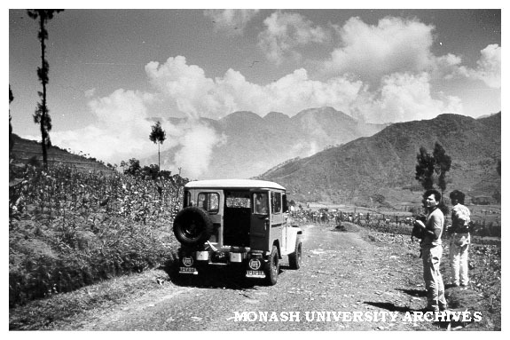Students Danny Vukadenovic (left) and Jerry Sukhyar heading towards volcano Dieng (centre background)