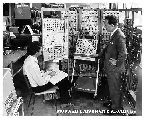 Professor K. Morsztyn (right) and student Stephen Blanch operating 'power system simulator'