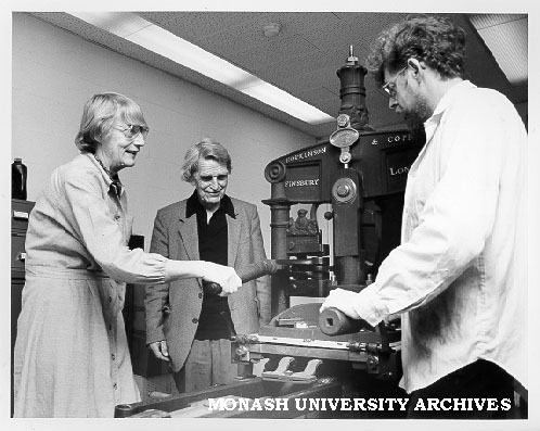 Professor Jean Whyte and Dr Brian McMullin (right) operating Albion press with Emeritus Professor Hector Monro looking on