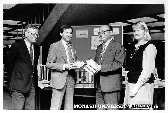 Professor Michael Pryles accepting gift of books from Professor Wa Da-Ying of Peoples' Republic of China, 12th International Congress of Company Law; Acting Dean of Law, Associate Professor Henry Finlay looking on