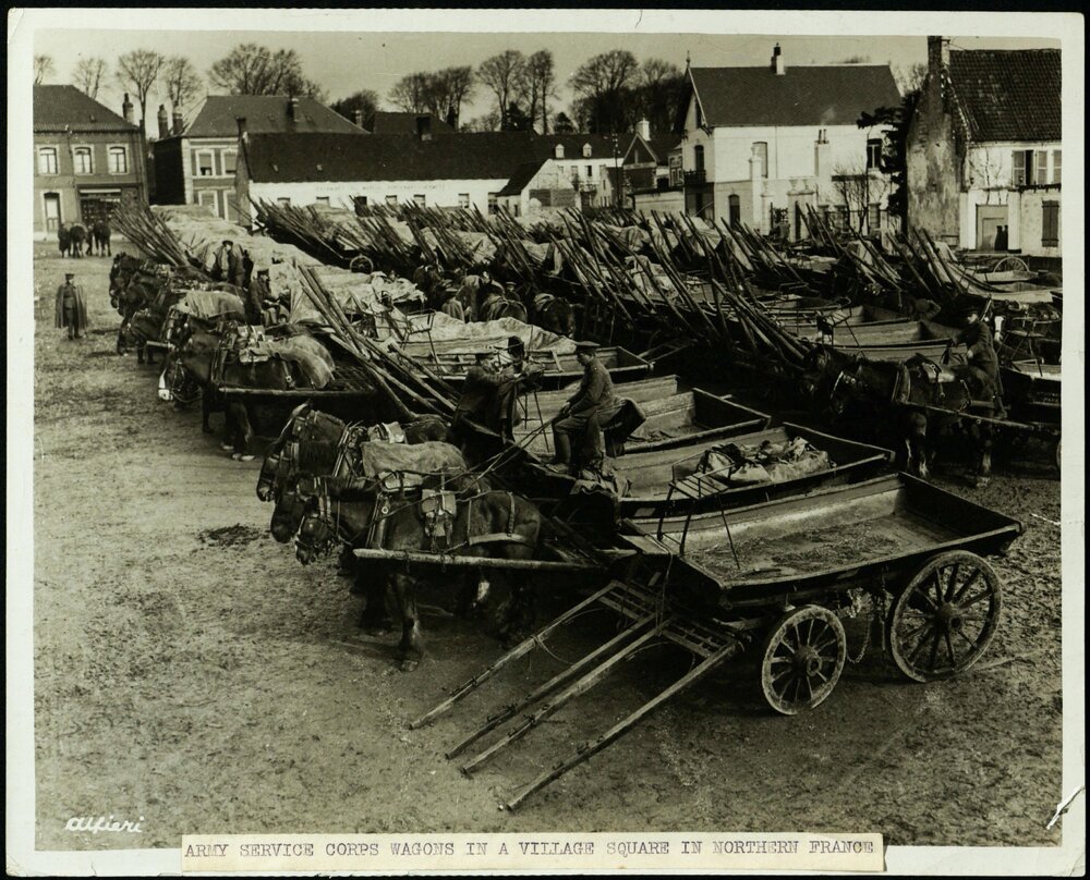 Army Service Corps wagons in a village square in Northern France