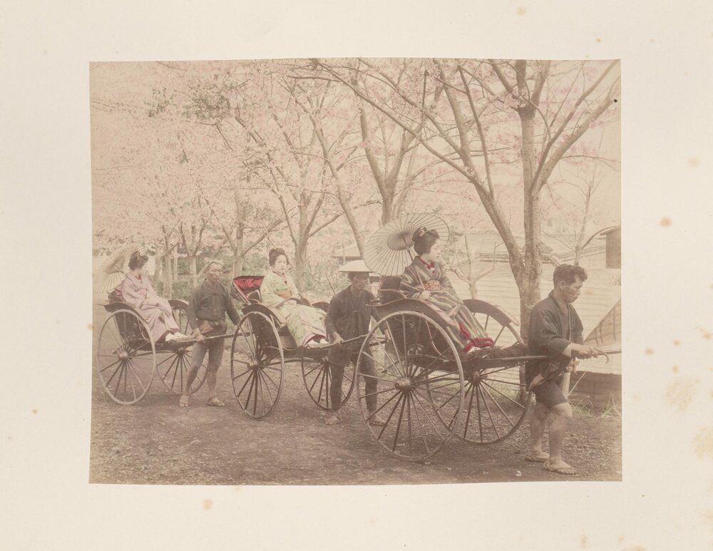 Three women being transported in a rickshaws