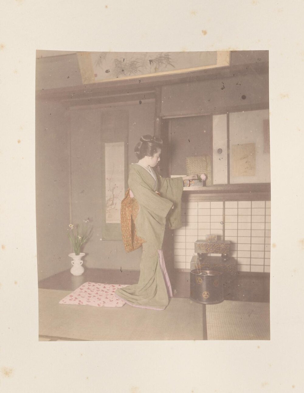 Women placing a rose on a shelf