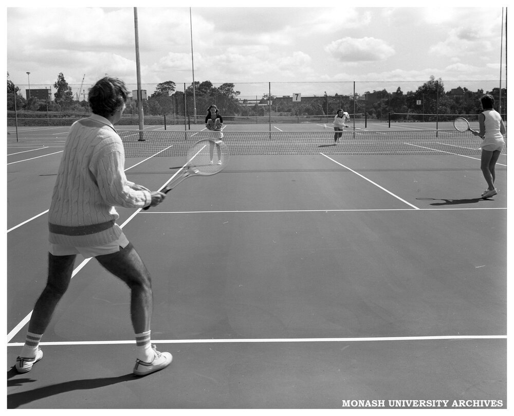 Vice-Chancellor Ray Martin trying out the new tennis courts in a mixed doubles match with Alan Farley, Janice Joosse and Caroline Fair 