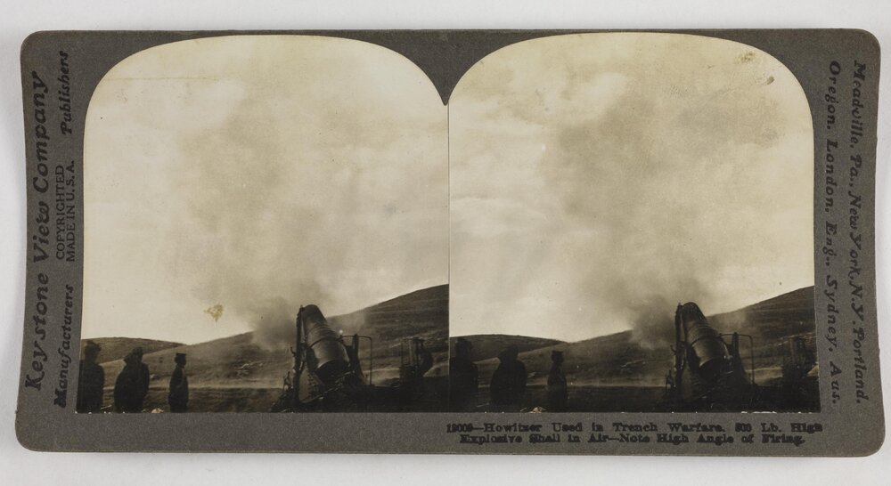 Howitzer used in trench warfare.  800 lb. high explosive shell in air-note high angle of firing