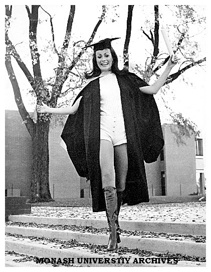 Professional model and Bachelor of Arts graduate Lucy Kiraly on steps near Religious Centre wearing a yellow chamois hot-pants suit.