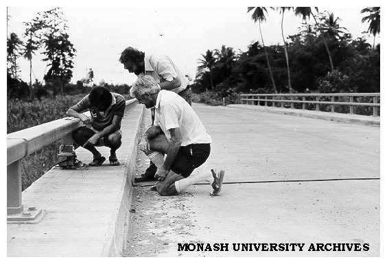 Geography students positioning traffic counter on Angabunga River bridge, Mr Stuart Hoverman, Father Michael Kennedy and Tony Simonelli