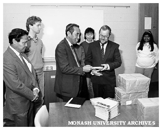 Professor Mahmud Zaki (centre left) Cultural and Educational Attache for Indonesian Embassy in Canberra presenting gift of books to acting chairman of department of Indonesian and Malay, Mr Paul Tickell