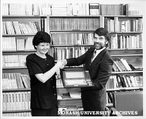Helen Marriott being presented with word processor with Japanese keyboard, by Fujitsu Australia's Gary Ceasar